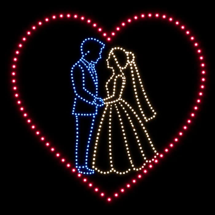 Bride and groom inside a heart wedding drone show figure made from glowing dots